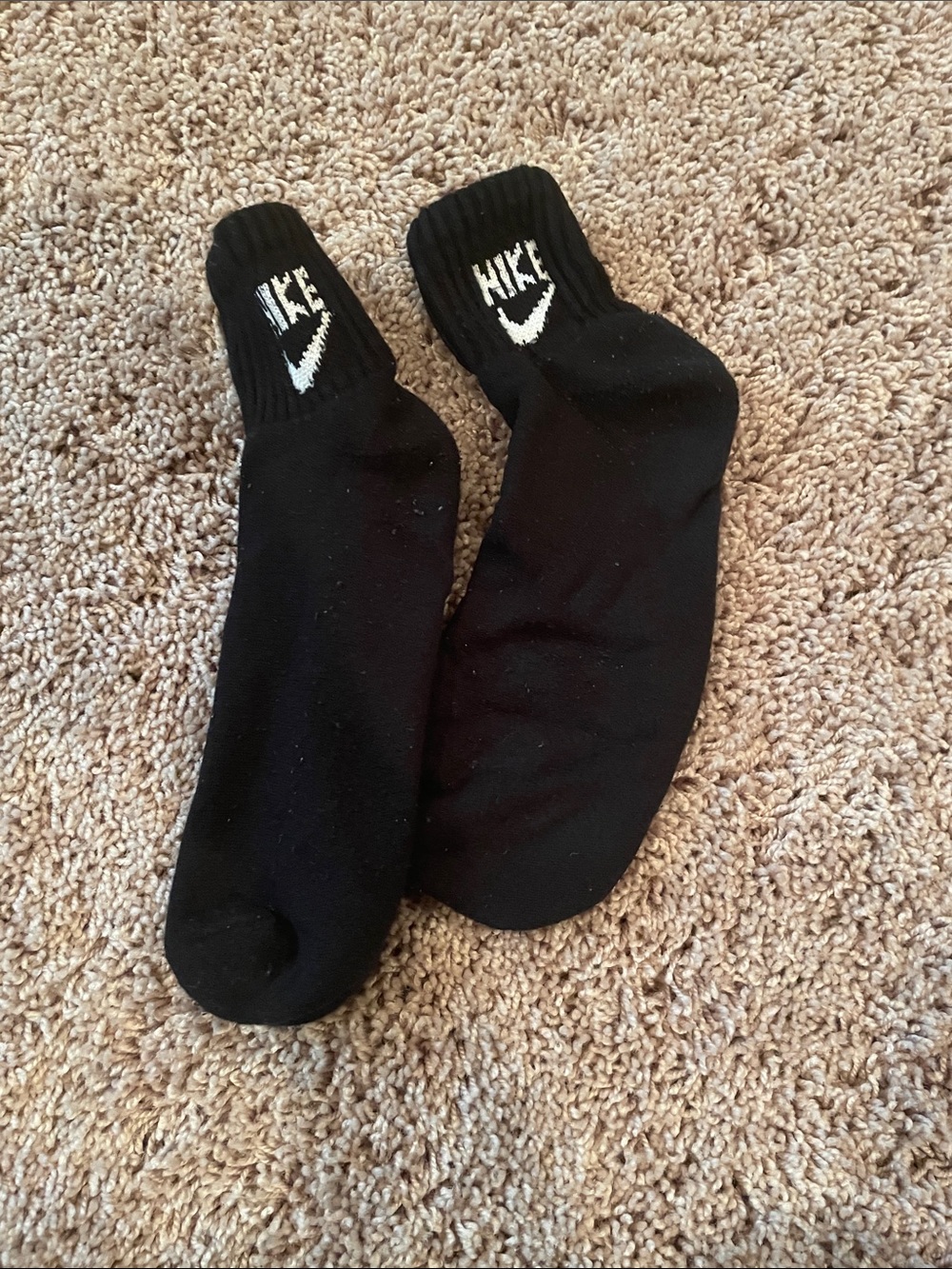 Gently worn Nike Men's Black Crew Socks with White Swoosh Logo